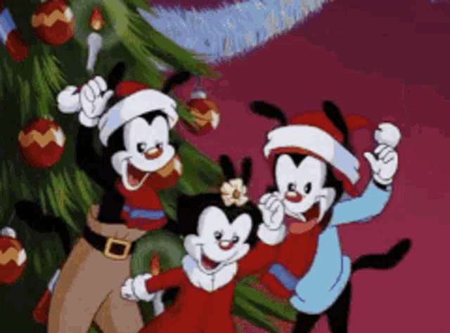 a group of cartoon characters wearing santa hats are standing next to a christmas tree