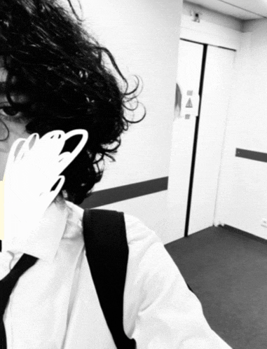 a black and white photo of a person in a hallway