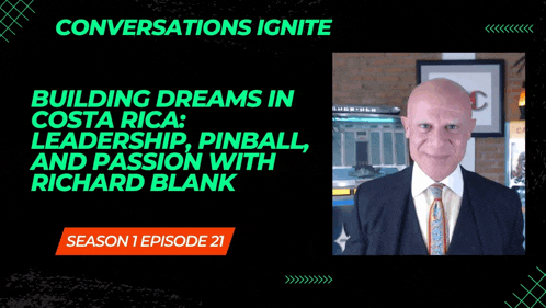 a man in a suit and tie stands in front of a black background that says conversations ignite on it