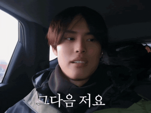 a man in a car with korean writing on the side