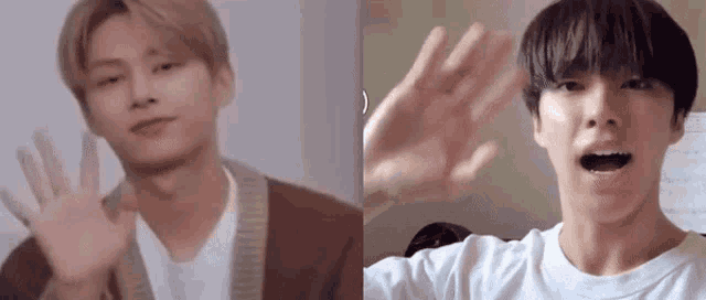 two young men are waving their hands in front of a camera .