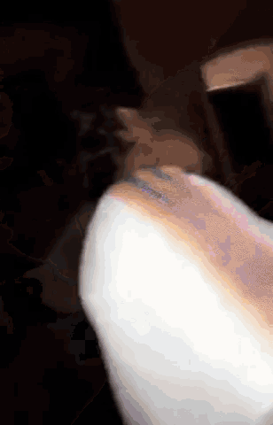 a close up of a person eating cotton candy in the dark