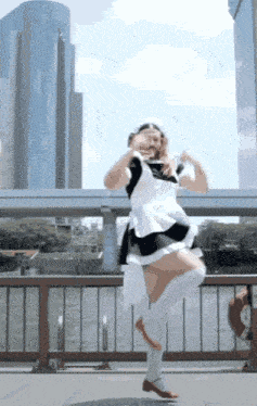 a woman in a maid costume is standing on one leg