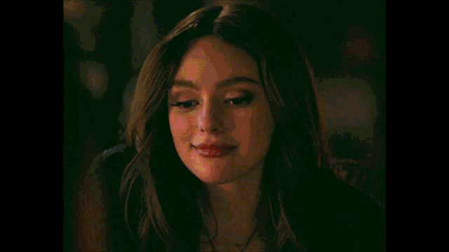 a close up of a woman 's face with a smile on her face .
