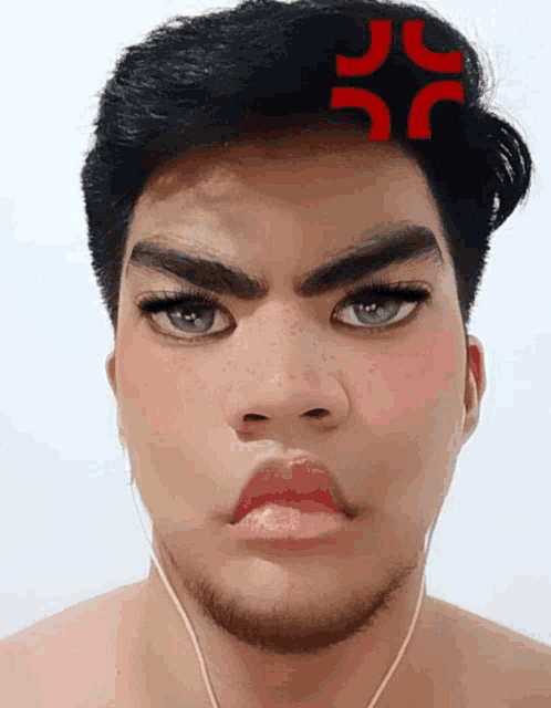 a man with a red sticker on his forehead that says jc