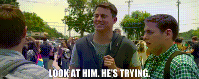 a man talking to another man with the words look at him he 's trying on the bottom