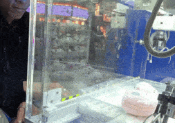 a man is playing a game with a machine that has a sign that says 5:59 on it