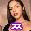 a close up of a woman 's face with a purple sticker that says ' x ' on it