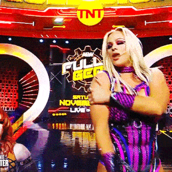 a woman in a purple outfit is dancing in front of a sign that says full gear