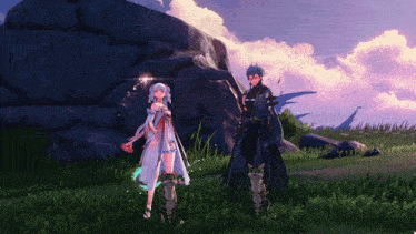 a man and a woman standing next to each other in front of a large rock