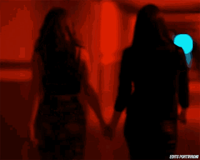 two women walking down a hallway with the words edits portirroni on the bottom right
