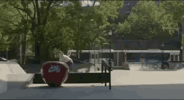 a person is doing a trick on a red nike skateboard