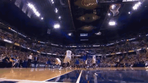 a basketball game is being played in a stadium sponsored by busch
