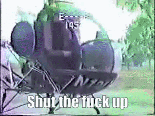 a close up of a helicopter with the words `` shut the fuck up '' written on the bottom .