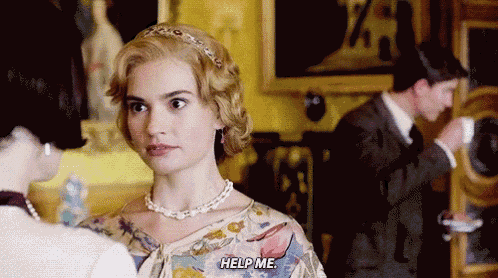 a woman in a floral dress is talking to another woman and says help me