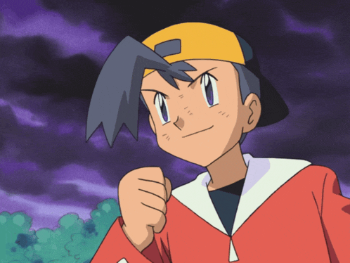 a boy wearing a red jacket and a yellow hat