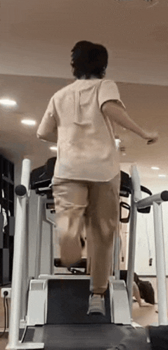 a person is walking on a treadmill in a gym .