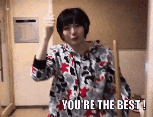 a woman is holding a mop and says you 're the best