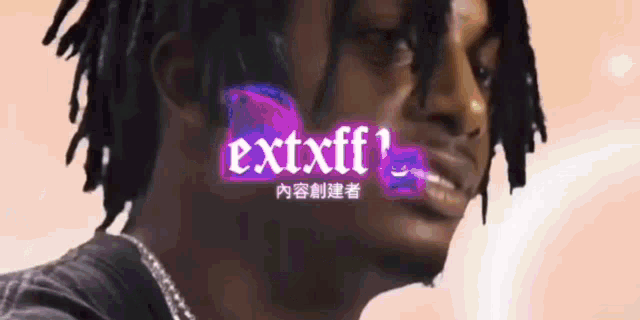 a close up of a man 's face with the word extxff written in purple