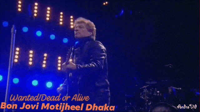 a man playing a guitar with the words wanted dead or alive
