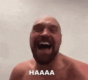 a shirtless man with a beard is laughing with his mouth open and the word haaaa written on the bottom .