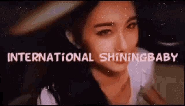 a close up of a woman 's face with the words `` international shining baby '' above her .