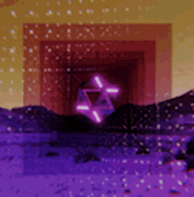 a purple background with a triangle in the middle and mountains in the background