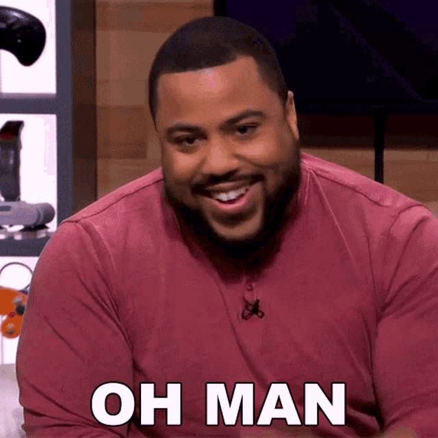 a man in a red shirt says oh man in white letters