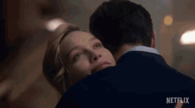a man and a woman hugging each other and the woman is saying `` i 'm so glad '' .