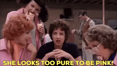 a group of women are sitting around a table eating ice cream and talking .