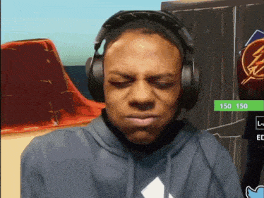 a man wearing headphones and a hoodie with 150 150 on the bottom right corner