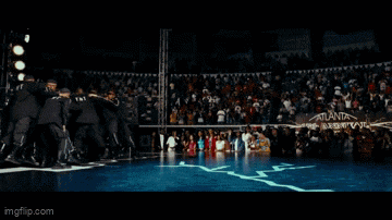 a man is doing a handstand in front of a crowd of people ..