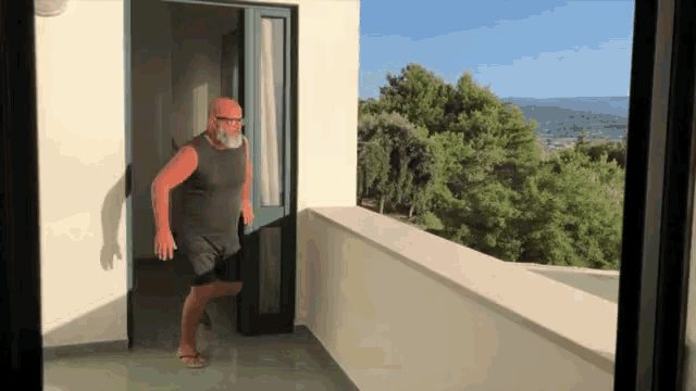 a man standing on a balcony with a view