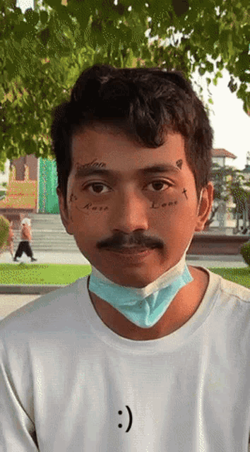 a man wearing a face mask has a tattoo on his face that says " lone "