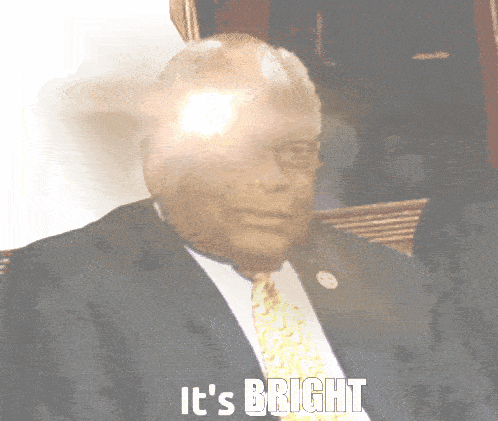 a man in a suit and tie with the words " it 's bright " above him