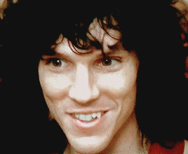a close up of a man 's face with a smile on his face