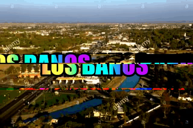 an aerial view of a city with the words los danos written in rainbow colors