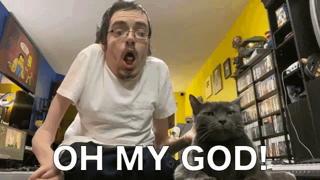 a man holding a cat with the words oh my god