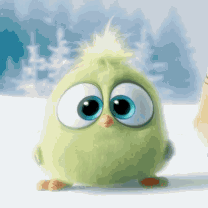 a green stuffed animal with big blue eyes and a yellow tail