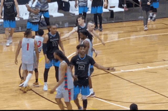 a group of basketball players on a court with one wearing the number 1