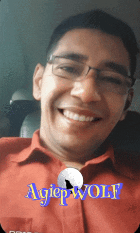 a man wearing glasses and a red shirt is smiling with the words agiep wolf behind him