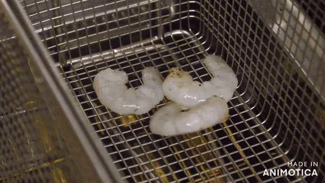shrimp are being cooked in a fryer with the words made in animatica on the bottom