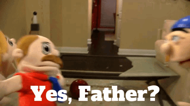 a puppet says yes father in front of a table