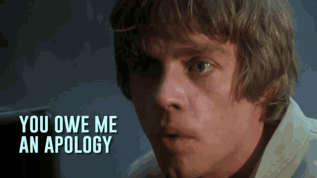 a close up of a man 's face with the words " you owe me an apology " above him
