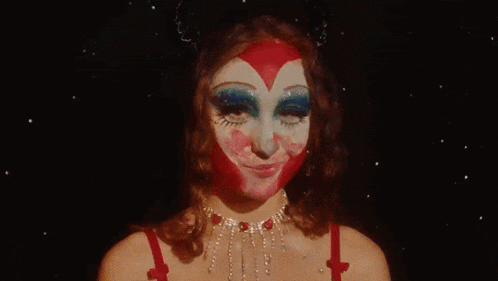 a woman with makeup on her face and a can of diet dr pepper in the background