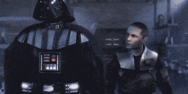 a man is holding a red light saber in his hand .