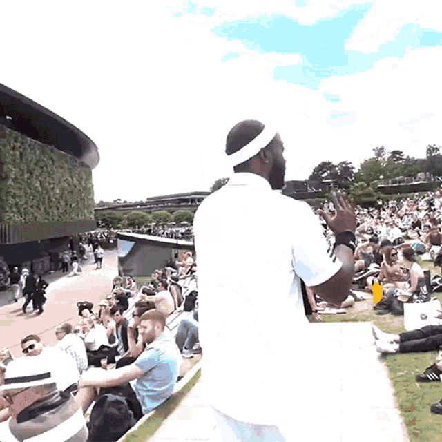 a man wearing a headband is standing in front of a crowd