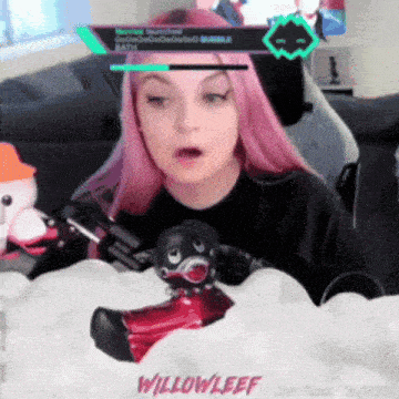 a girl with pink hair is playing a video game with the name willowleef on the bottom