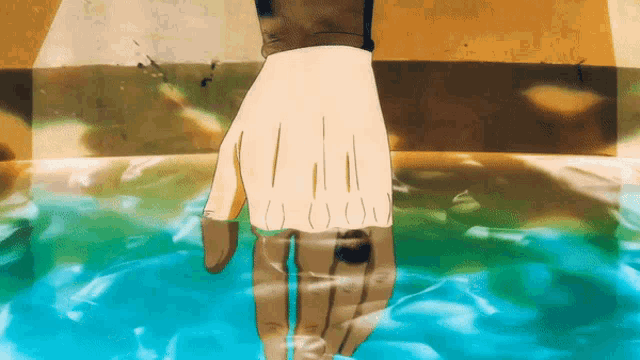 a hand is reaching out into the water