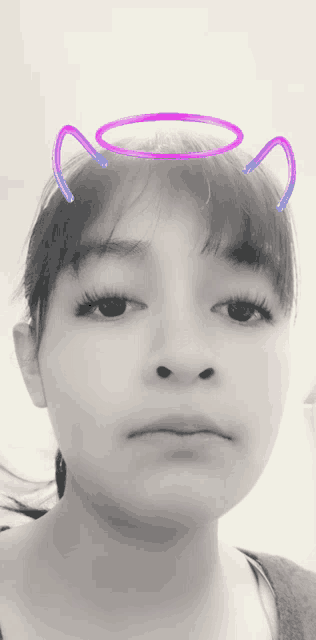 a girl with a purple halo on her head looks at the camera